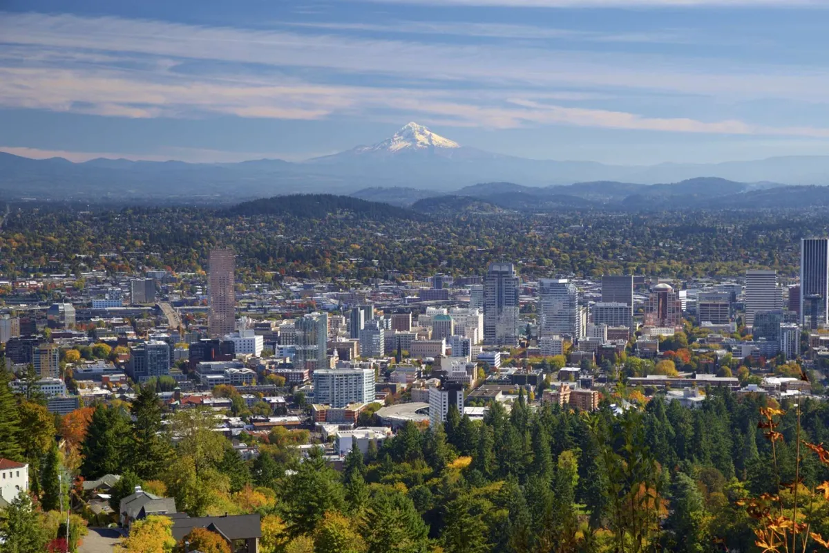 A panoramic view featuring Mount Hood and the downtown skyline set against lush greenery, this image evokes a sense of place and adventure, highlighting the proximity to both urban and natural attractions.
